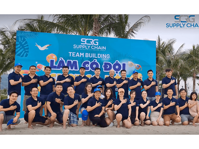 SCRG Vietnam team members posing on beach during company team building event.